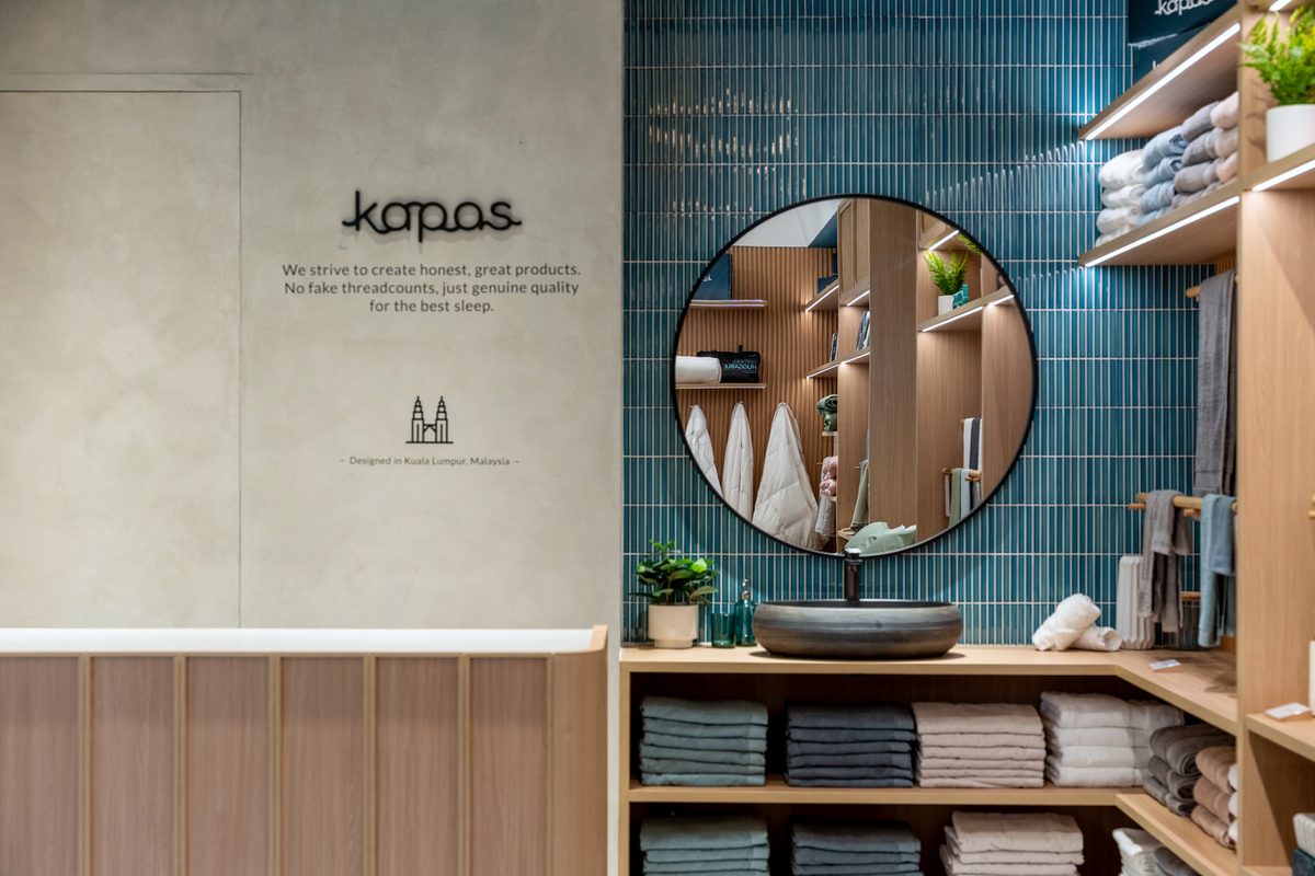 Interior of Kapas Living showing timber shelving and layered light