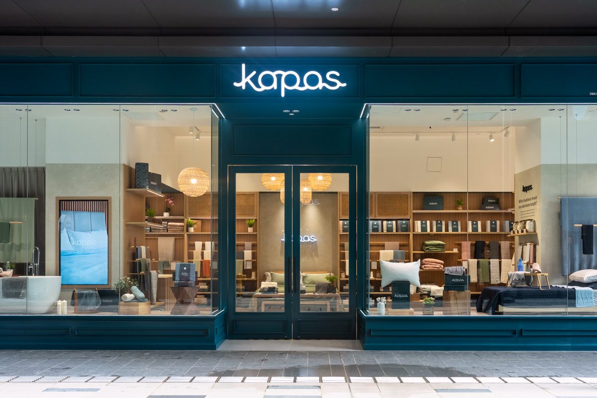 Deep blue timber shopfront of the Kapas Living store at TRX